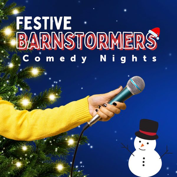 A yellow cardigan-ed hand holding a microphone against a blue background, with a dressed Christmas tree and a snowman around it. Text: Festive Barnstormers Comedy Nights.