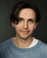 A headshot of East is East cast member Matthew Khan. He has his ears pierced and wears a jumper.