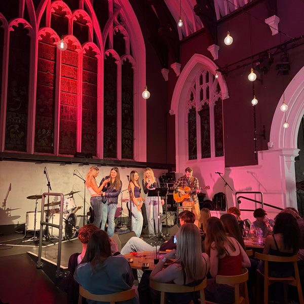 A group of young people playing various instruments on the Altar Stage at Salisbury Arts Centre.