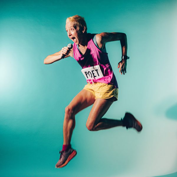 Poet P Burton-Morgan dressed in running gear and holding a microphone, leaping against a blue background.