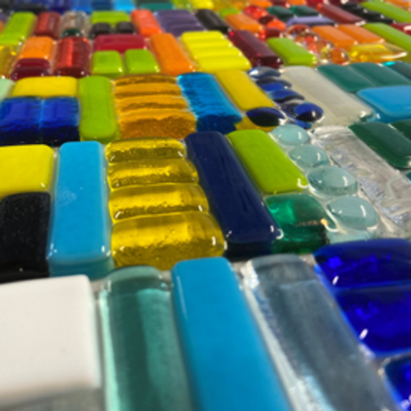 Fused stained glass laid out on a table.