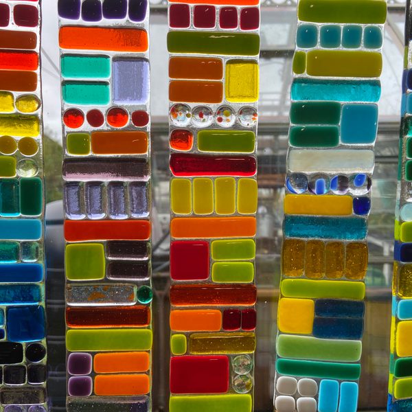 Fused stained glass hanging from a window.