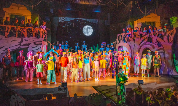 Full cast of The Jungle Book performing on stage.