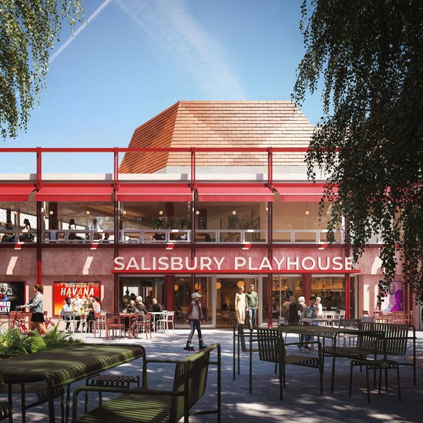 An artist's impression of the exterior of Salisbury Playhouse with a red-framed façade and large glass windows, showing café tables and chairs in a paved courtyard where people are seated and walking.