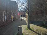 The alley between Salisbury Playhouse and City Hall. The audience will be moved to gather here at the start of Act One, after the evacuation; this space will also be used at the end of the performance as the audience forms part of the funeral procession for Juliet, walking between the buildings towards the roundabout.