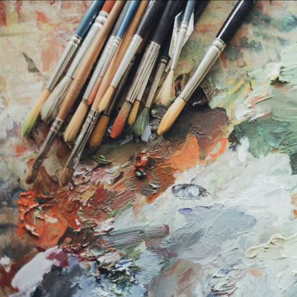Paintbrushes and an in-use paint palette.