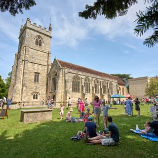 Salisbury Arts Centre on a sunny day with people enjoying the Family Fiesta