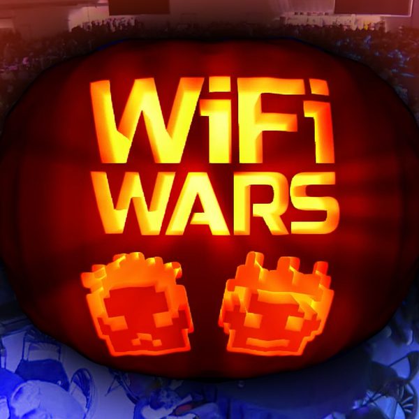 A large, glowing graphic with the words “WiFi WARS” in bright yellow-orange letters. Below the text are two pixelated, orange icons resembling retro video game characters. Behind the graphic, a wide view of a crowded cabaret style auditorium, with people seated at tables. The background is heavily blurred and tinted with blue and red lighting.